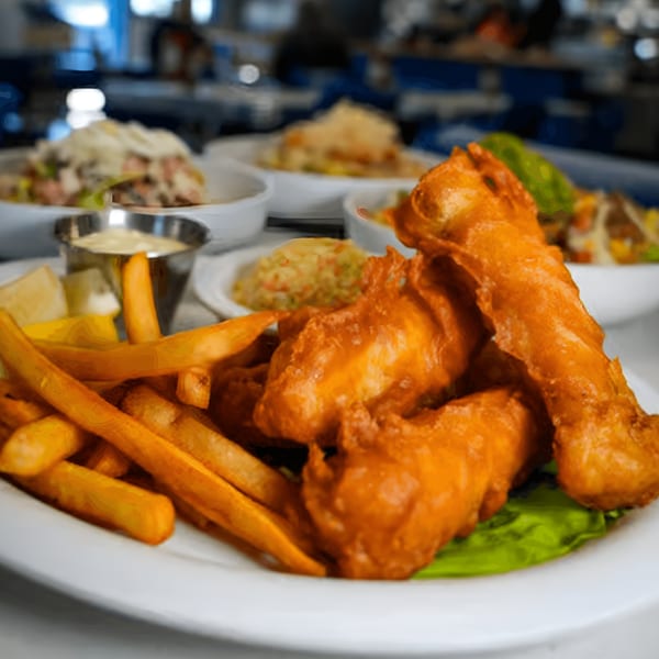 Crispy fish and chips with tartar sauce and lemon, served at Eat at Joe's diner.