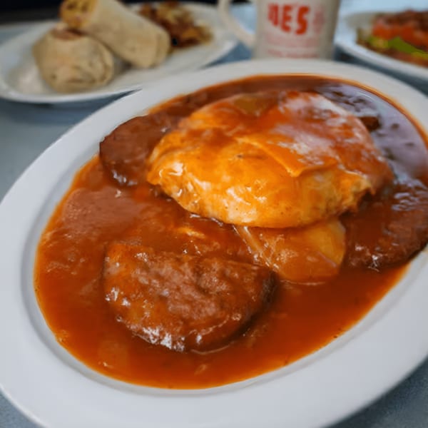 A plate of chili cheese omelet with hash browns, served at Eat at Joe's diner.